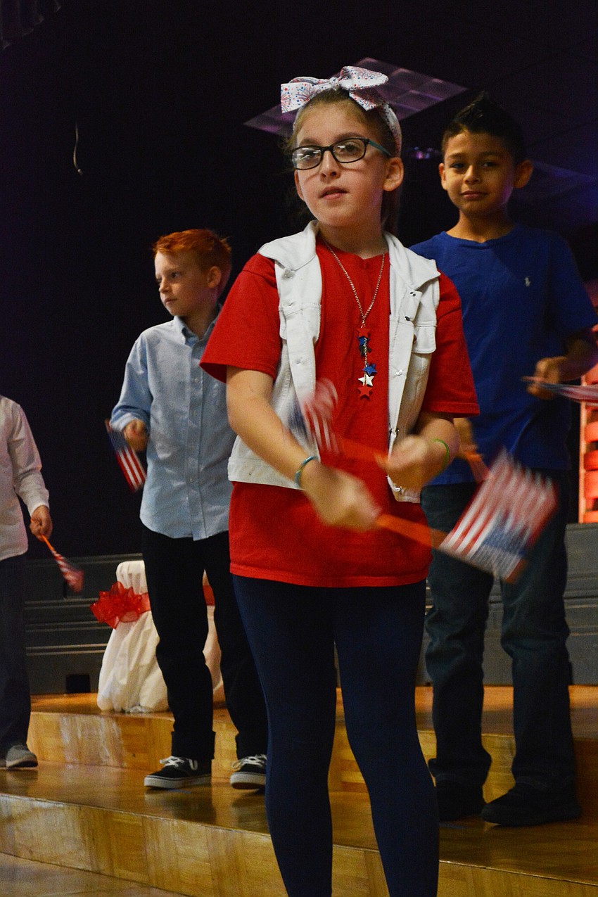 Madison Bryant performs a flag routine to introduce the 