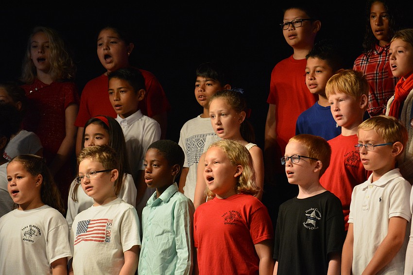 Children sign a song about freedom.