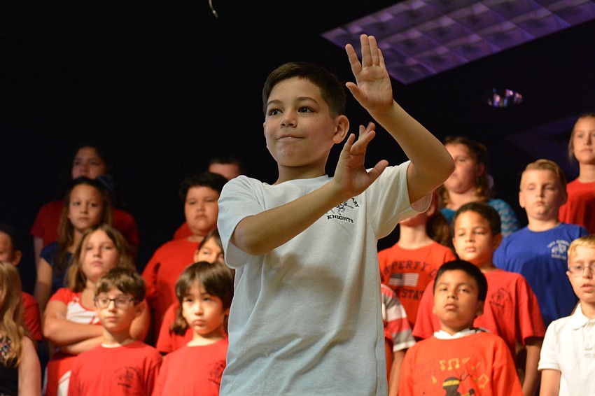 Nathan Niver leads his class in signing 