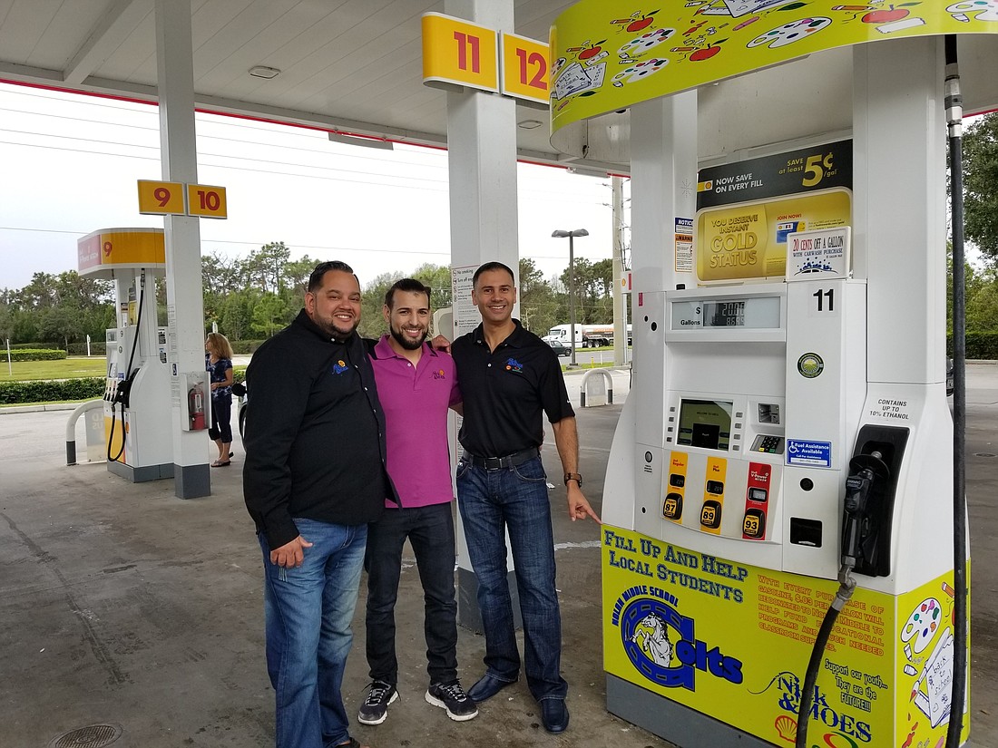 Nick and Moeâ€™s Shell Gas Station managers Jose Rodriguez and Mike Hass and owner Nick Salem show off one of their pumps aimed at helping R. Dan Nolan Middle School and Gilbert W. McNeal Elementary.