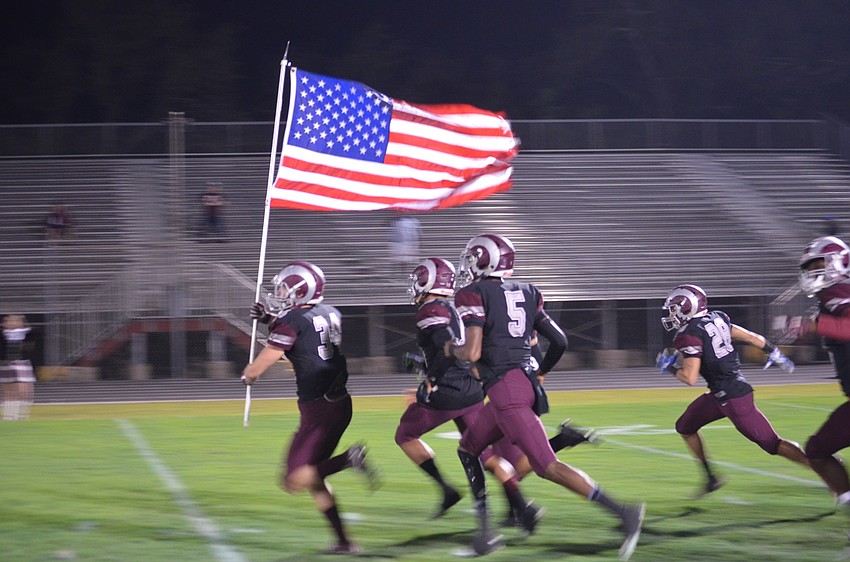 Garrett Furlan (No. 34) leads his teammates onto the field at the start of the quarterfinal match up with Gateway.
