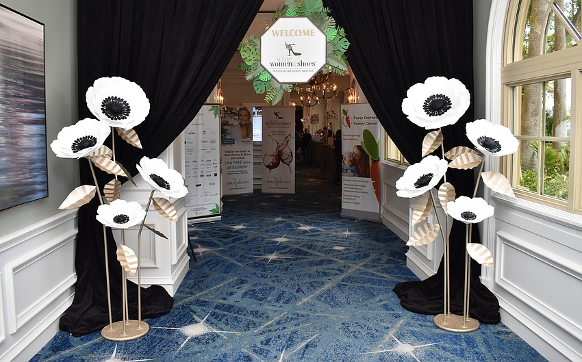 Guests entered through an elegant floral entryway created by CC’s Paper Artistry.