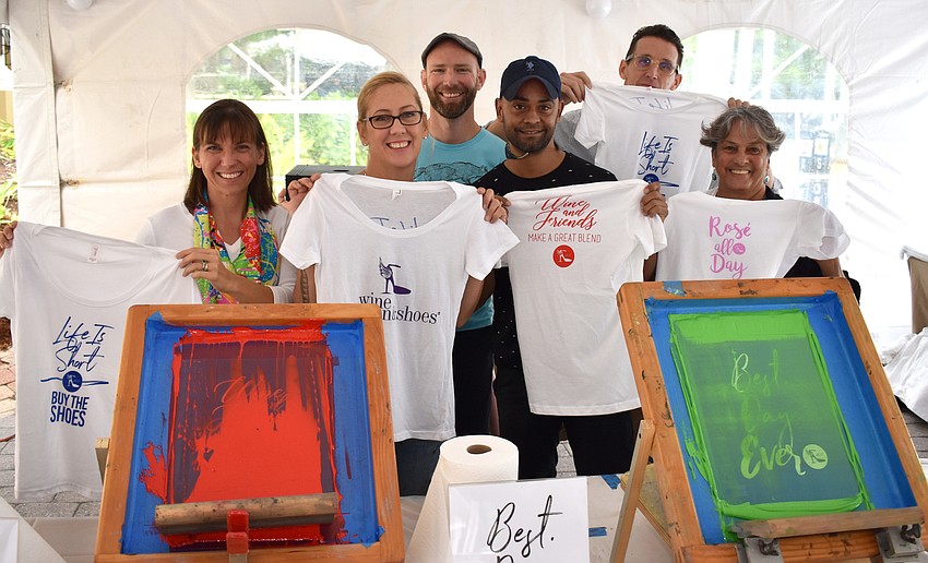 Julie Kanapaux, Jenny Medved, Zach Gililland, Javier Rodriguez, Steven Strenk and Elena De La Ville show off their work at the screen printing station.