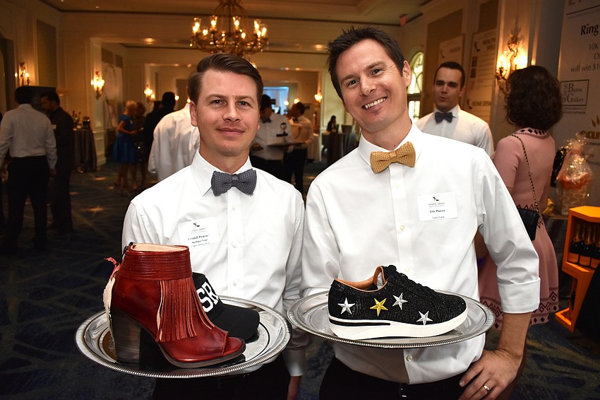 Solemen Kendall Peacock and Eric Piazza show off the shoes they were selling.