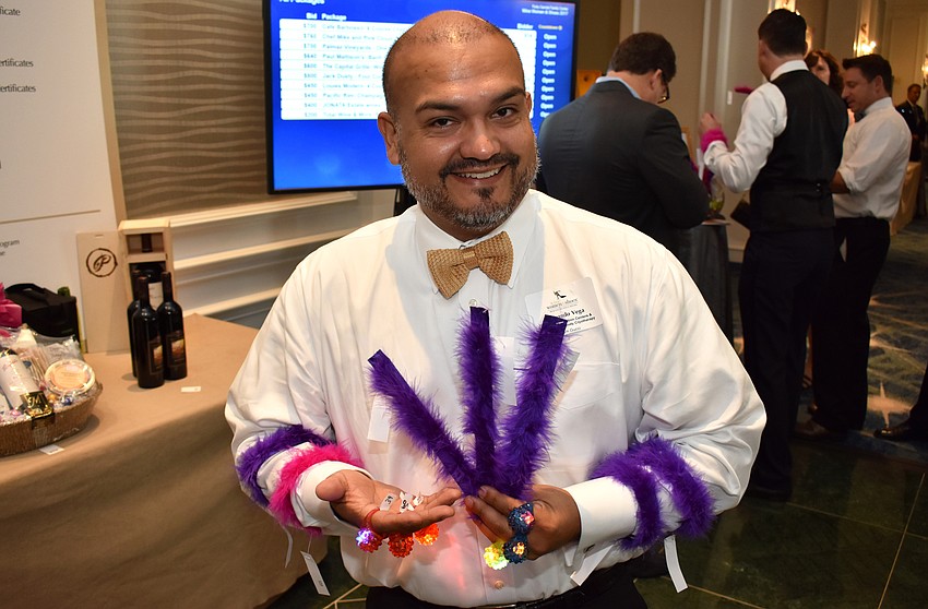 Fernando Vega models the bracelets and bling rings guests purchased to benefit Forty Carrots.
