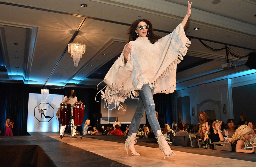 Models strut the runway during a lively fashion show by The Met.