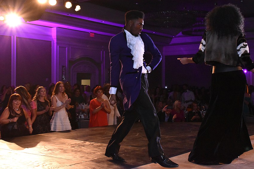 A Prince tribute performer interacted with models in a lively fashion show by The Met.