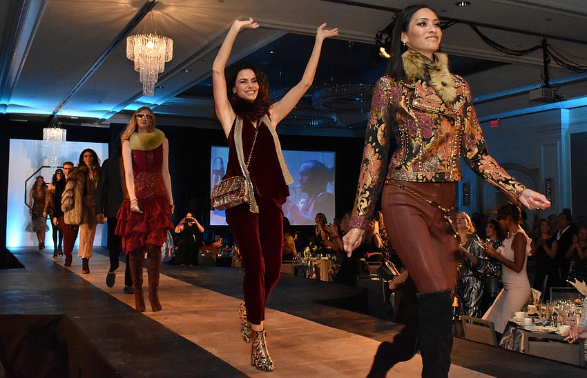 Models strut the runway for the fashion show closing.