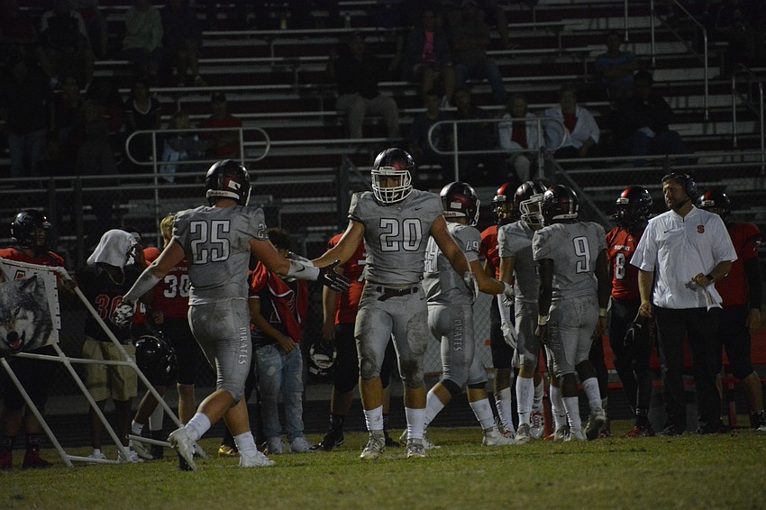Chase Knopf (25) and junior Tyler Pawelkoski (20) high-five after a defensive stop.