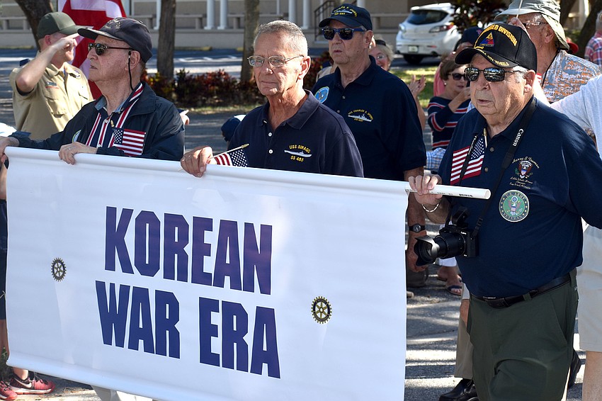 Korean War veterans walk the parade route on Bay Isles Road.