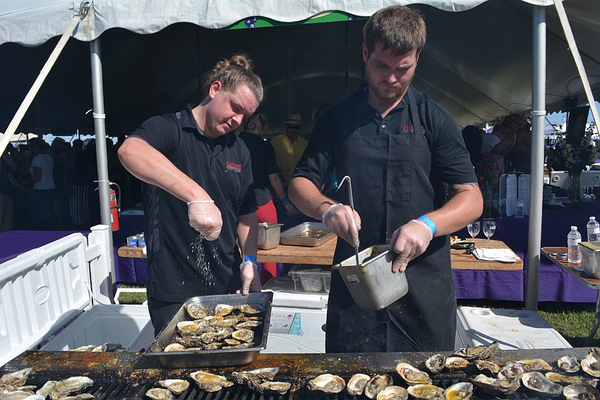 Seth Powell and Austin Kelley grill up oysters for Half Shell Seafood House.