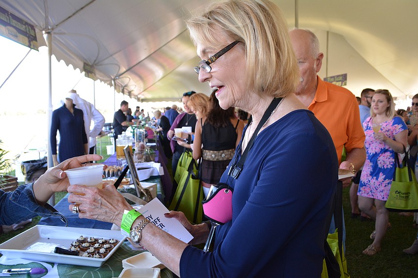 Lakewood Ranch's Mary Boswell gets a plate of desserts from a vendor.