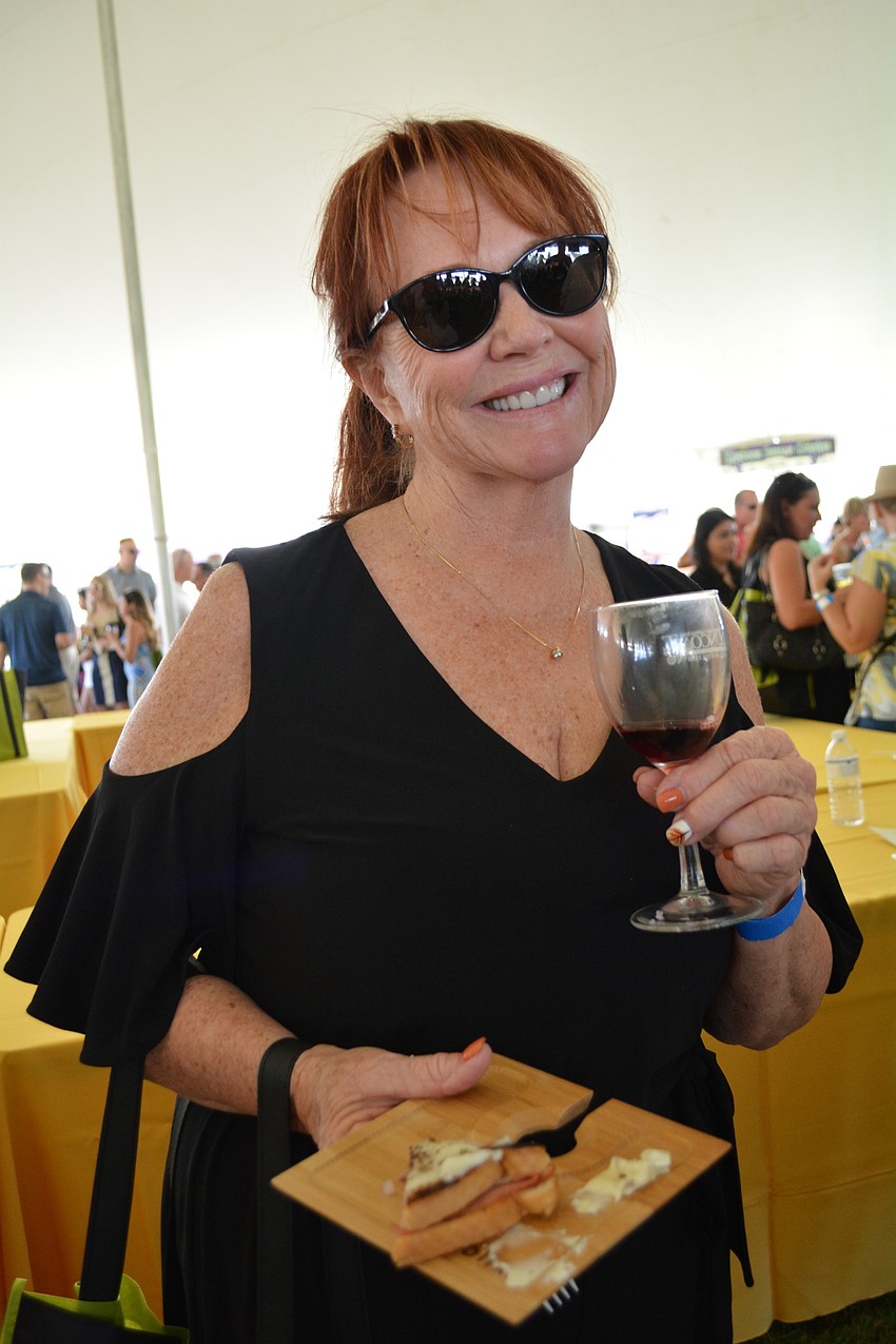 Debbie Balle, of Palm Aire, tries a red blend wine. 