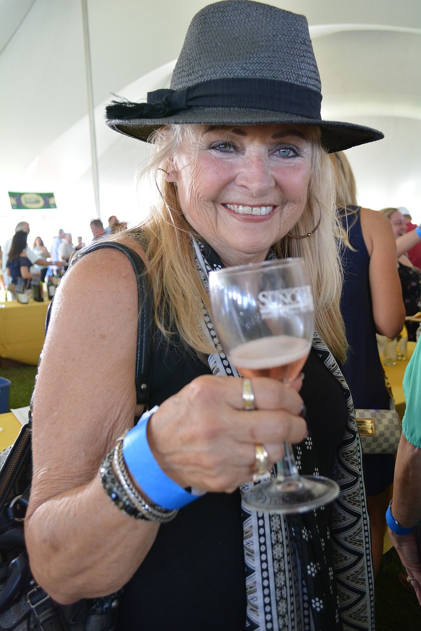 Jenae Warren, of North Port, samples wine. Of the food, she likes the lobster.
