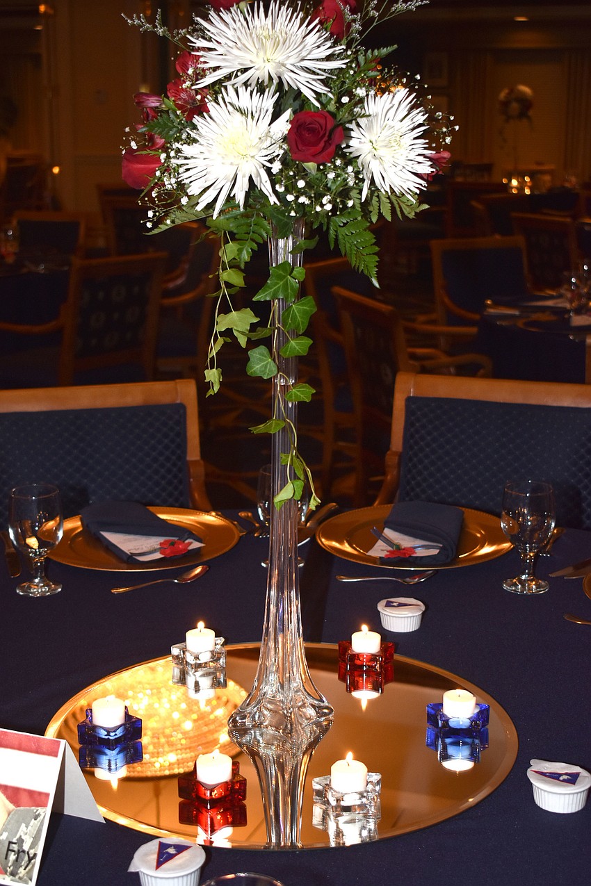 Patriotic-themed flowers and candles adorned each table.