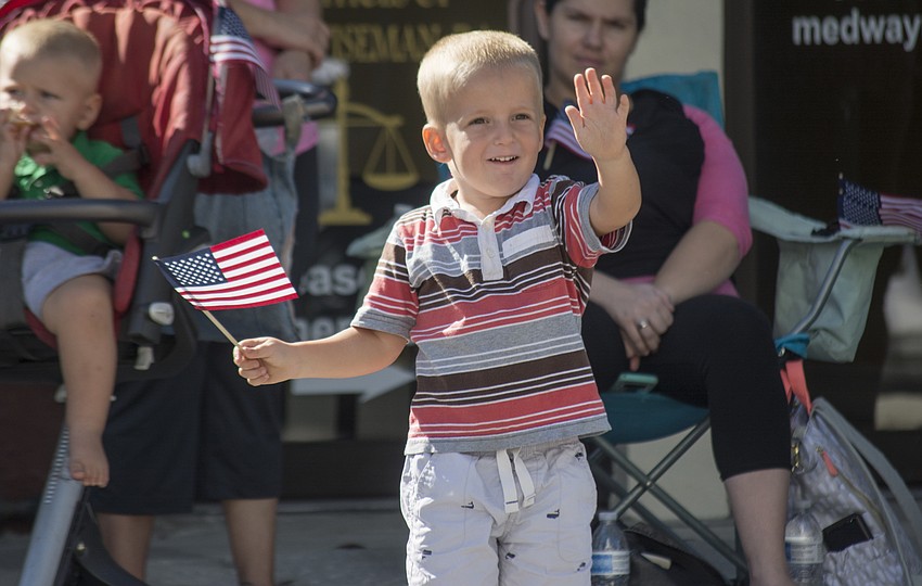 David Wallenstein waves as veterans march in Sarasota's Veterans Day Parade.