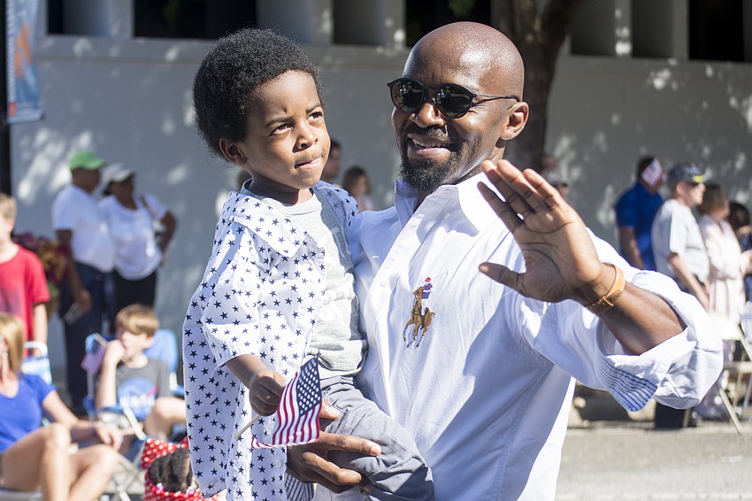 Oneil and Dayo Abiodun march in Sarasota's Veterans Day Parade.