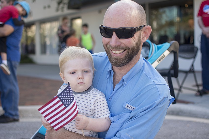 Sage and Zach Gilliland watch Sarasota's Veterans Day Parade.