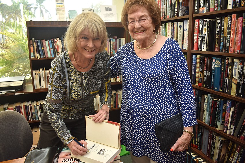 Pat Gussin signs a copy of “Come Home” for Ruth Strauss.
