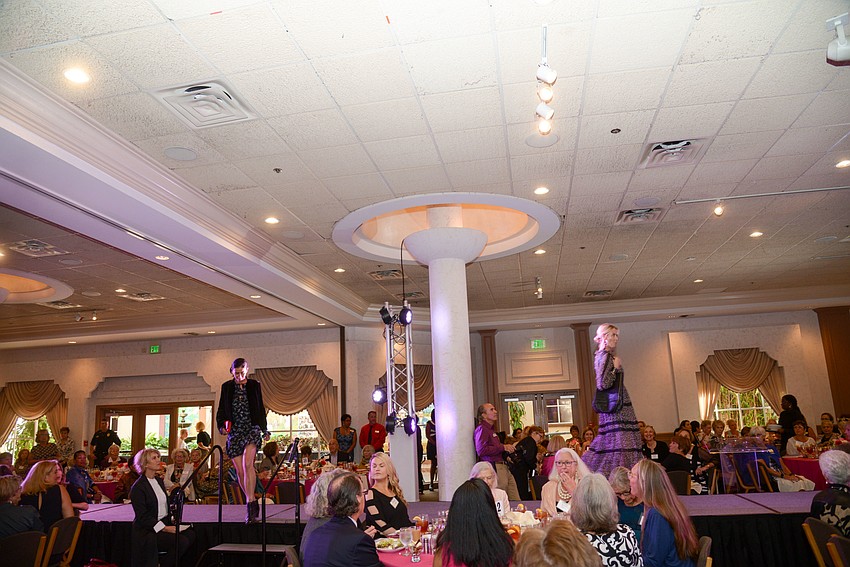 Models walk in the fashion show.