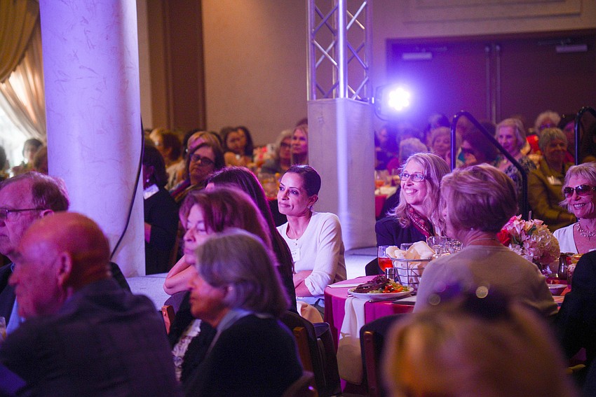 Guests enjoy the fashion show portion of the luncheon.