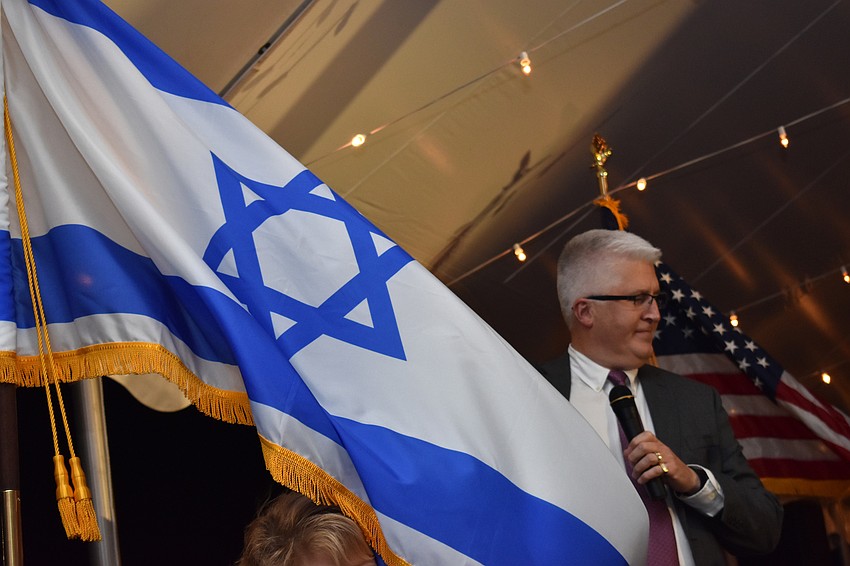 The Israeli flag flaps in the wind.