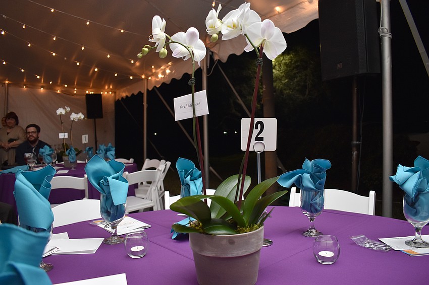 A floral centerpiece adorned every table.