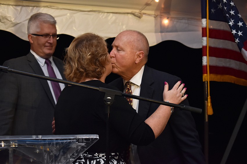 Scott Anderson thanks Lori Solomon for his surprise birthday cake with a kiss on the cheek.