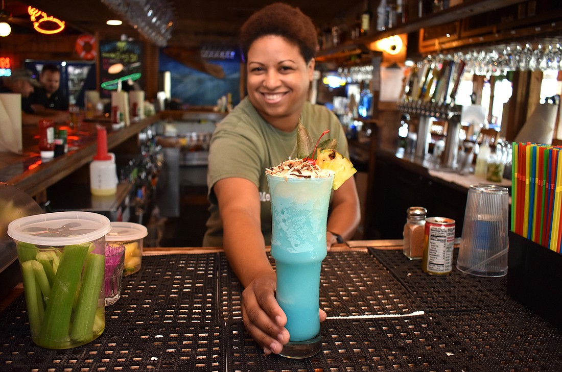 Phillippi Creek Village Restaurant & Oyster Bar&#39;s veteran bartender Jasmine Stanco serves a Caribbean Coolada. Photo by Niki Kottmann.