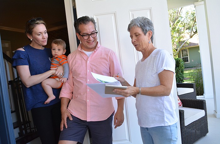 Becky and David Freidman, with son Maxwell, learn about the proposed Braden River Preserve and how the community would fund it, from Peggy Klimek, who lives down the street and is going door to door to talk with neighbors.