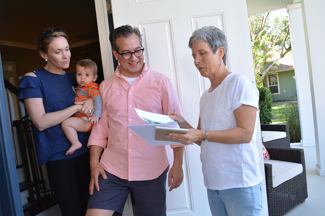 Becky and David Freidman, with son Maxwell, learn about the proposed Braden River Preserve and how the community would fund it, from Peggy Klimek, who lives down the street and is going door to door to talk with neighbors.