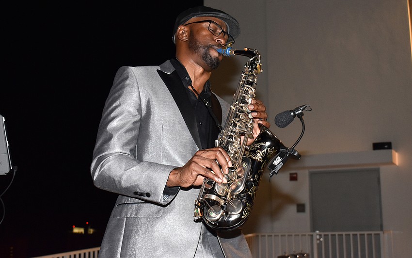 Saxophonist Marlon Boone performs for guests.
