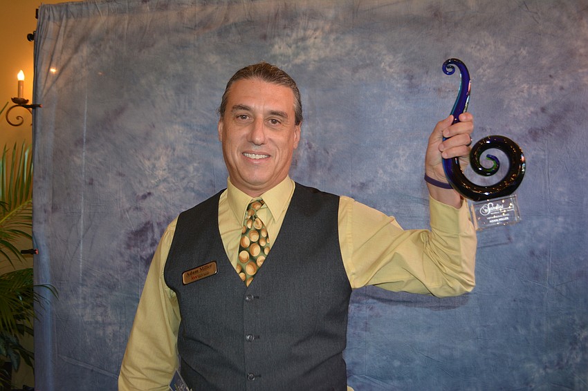 Adam Miller of Keller Williams shows off his Sandies award for Networking King.