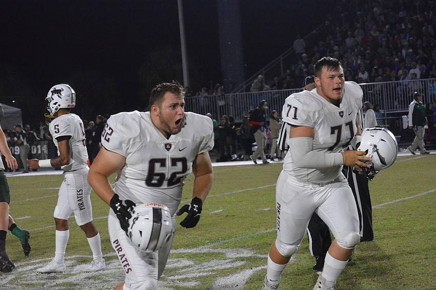 Braden River captains Luke Andrews (62) and Brendan Bengtsson (71) hurriedly join their teammates after winning the coin toss.