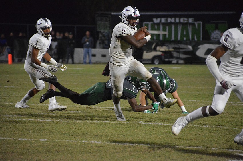 Pirates senior running back Deshaun Fenwick brushes off an attempted Indians tackle. Fenwick finished with 86 rushing yards and a touchdown on 16 carries.