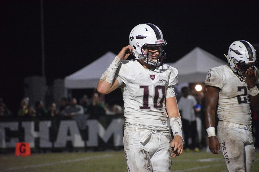 Bryan Gagg unstraps his helmet and Deshaun Fenwick wipes his face after a failed fourth-down conversion late in the game.