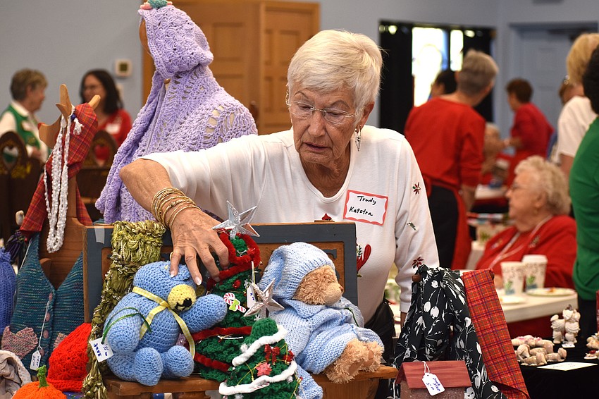 Trudy Katstra fixes a display of sewn items during the Christmas Bazaar.