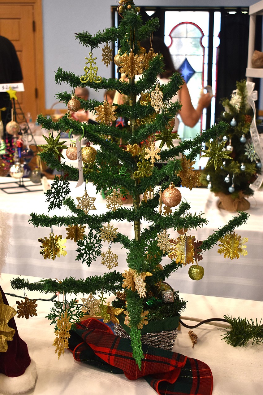 Christmas trees, like this one modeled after Charlie Brown’s Christmas tree, were on sale during the bazaar.