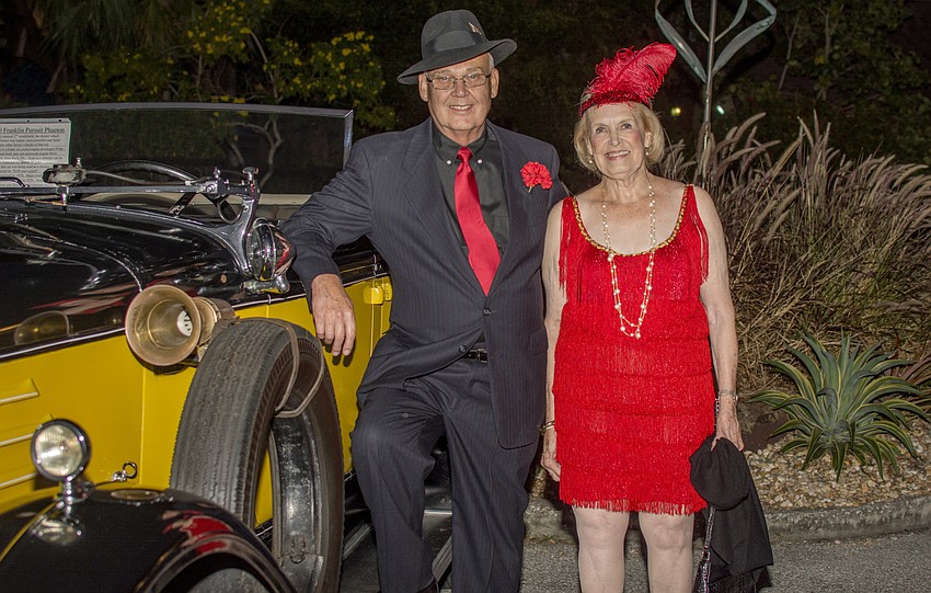 Ron and Joy Lightcap pose next to an antique car parked at the entrance of the Sarasota Garden Club's 90th anniversary celebration.