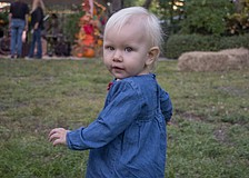 Casey Navarro plays in the park during the neighborhood's regular Tunes in the Park event.