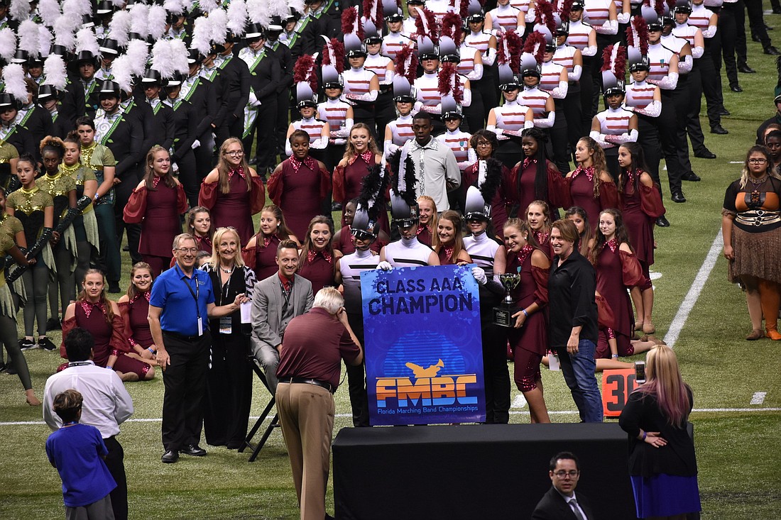 Braden River marching band members receive the 3A championships banner. Photo courtesy of Terri Behling.