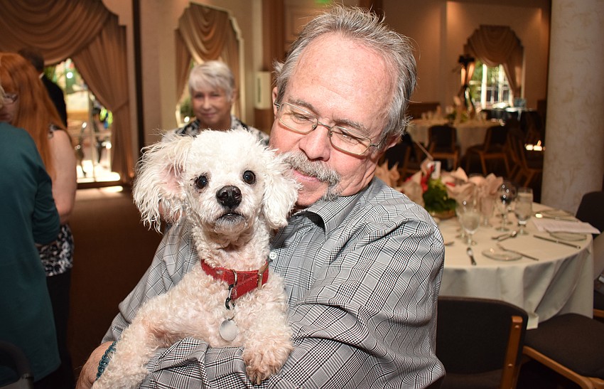 Charlie Sims holds Half Pint, who is available for adoption.