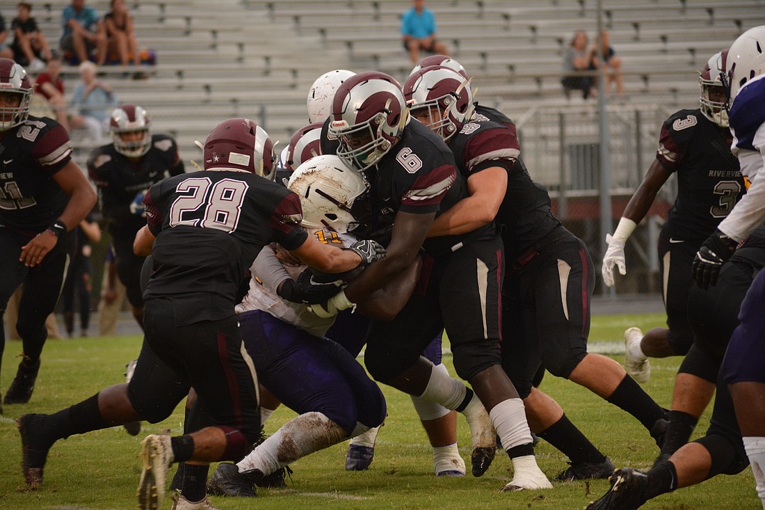 Senior Yunes Mezroub (28) and juniors Johnny Dawson (6) and Julian Lowenstein (9) make a gang tackle. It&#39;s play like this that lead to Riverview takeaways.