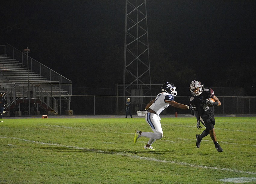 Senior Jamar Johnson evades a Panthers defender during a punt return.