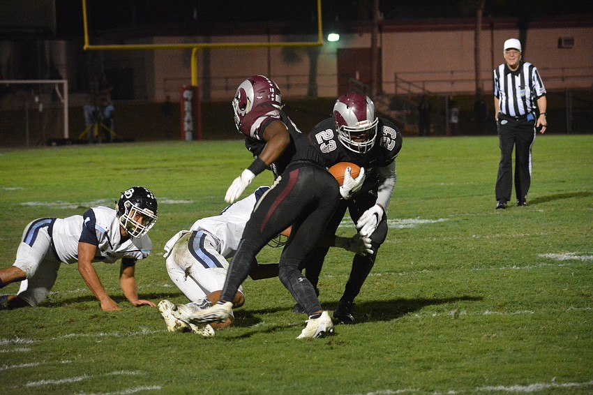 Freshman Michael Hayes (23) uses a Stephon Turner block to get upfield.