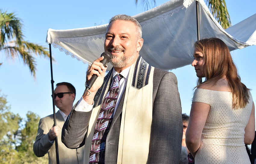 Rabbi Michael Shefrin of Temple Emanu-El leads the ceremony.