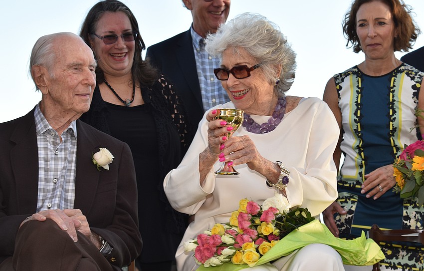 Carol Siegler laughs she she drinks the ceremonial wine during her vow renewal.