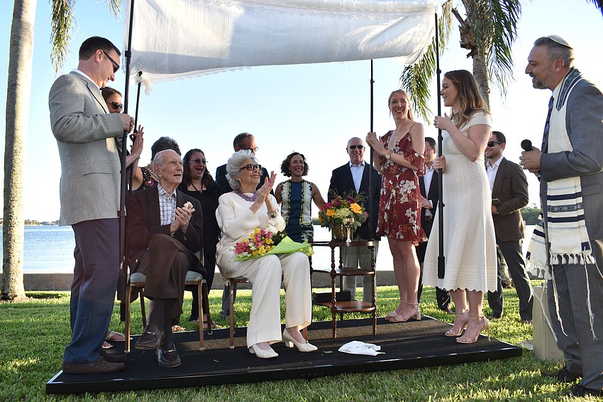 Mort and Carol Siegler clap with their children and grandchildren at the end of their vow renewal ceremony.