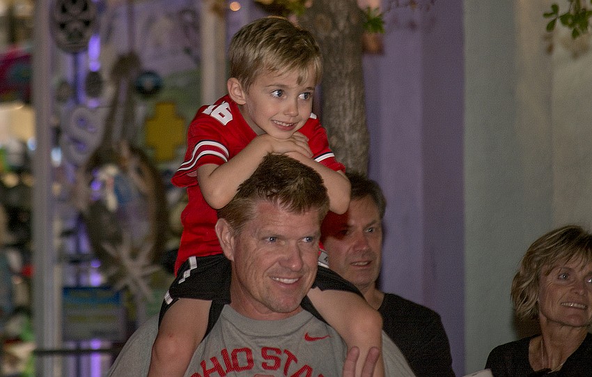 Ryan and Patrick Regan smile while watching the Siesta Key holiday parade.