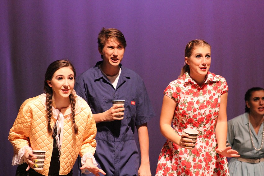 Lakewood Ranch High School theatre students Savanna Katter, Ty Dearing and Caroline Culbreath dance on stage with coffee cups during dress rehearsal.